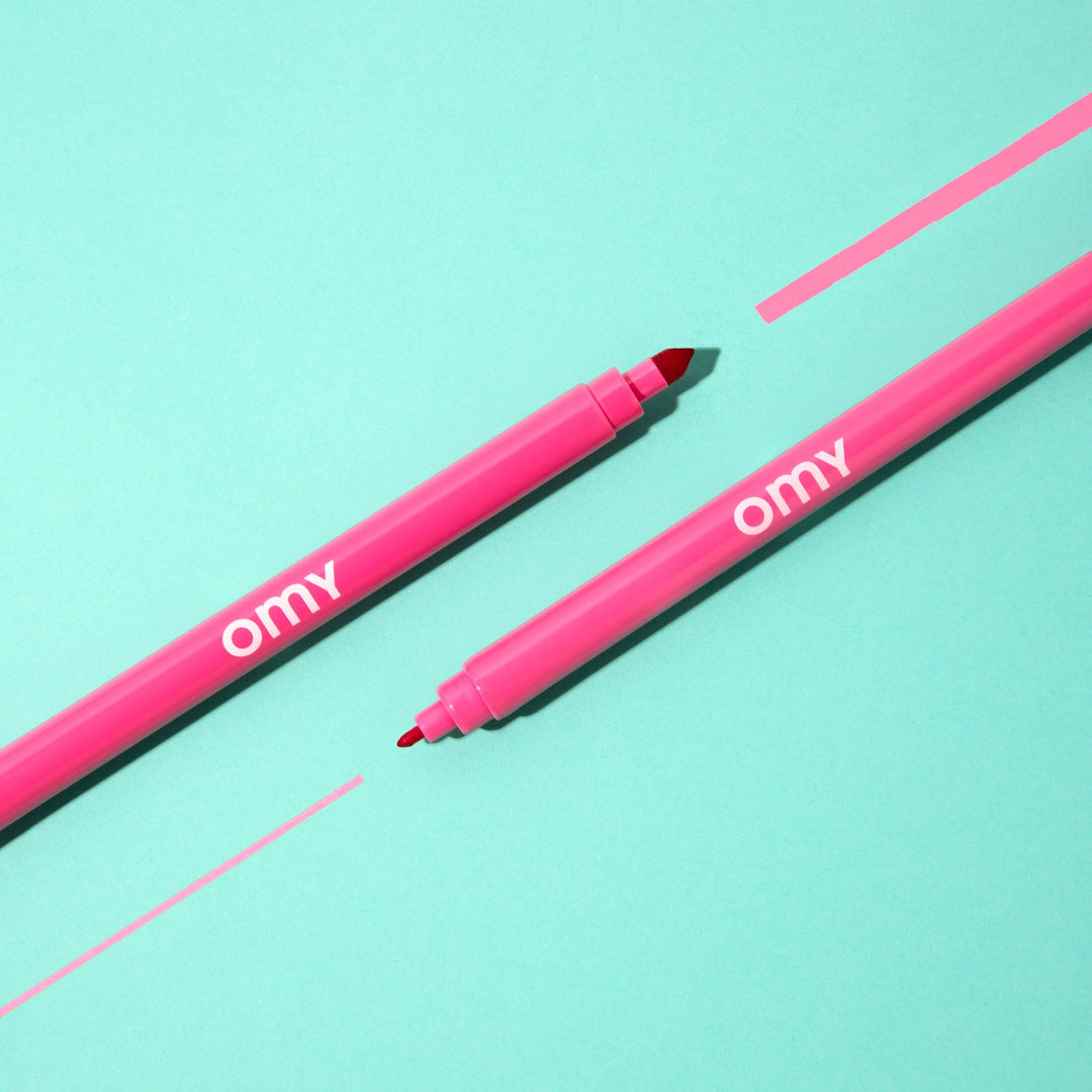 Ultra-washable marker drawing a line on a teal background