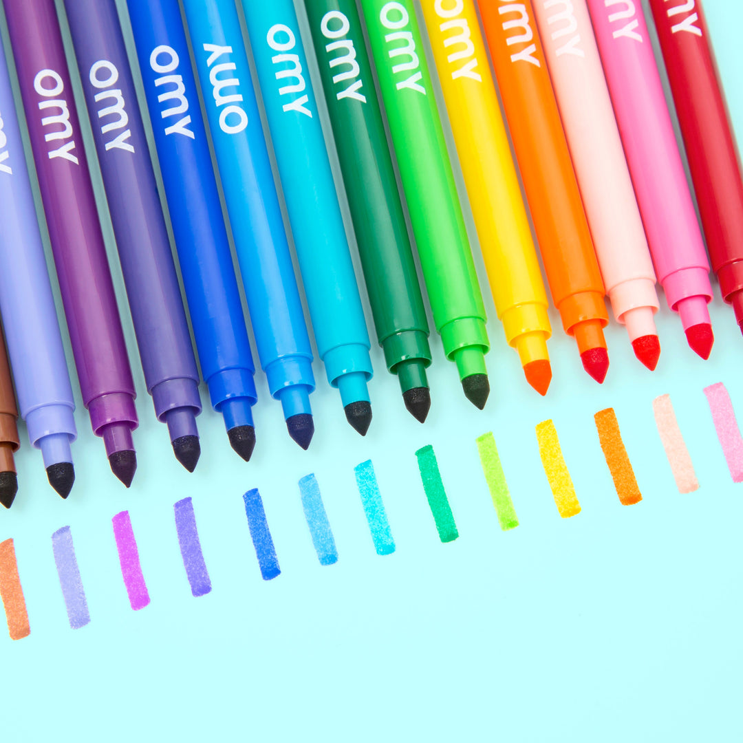 Fanned set of ultra-washable markers in rainbow colors on a pink background