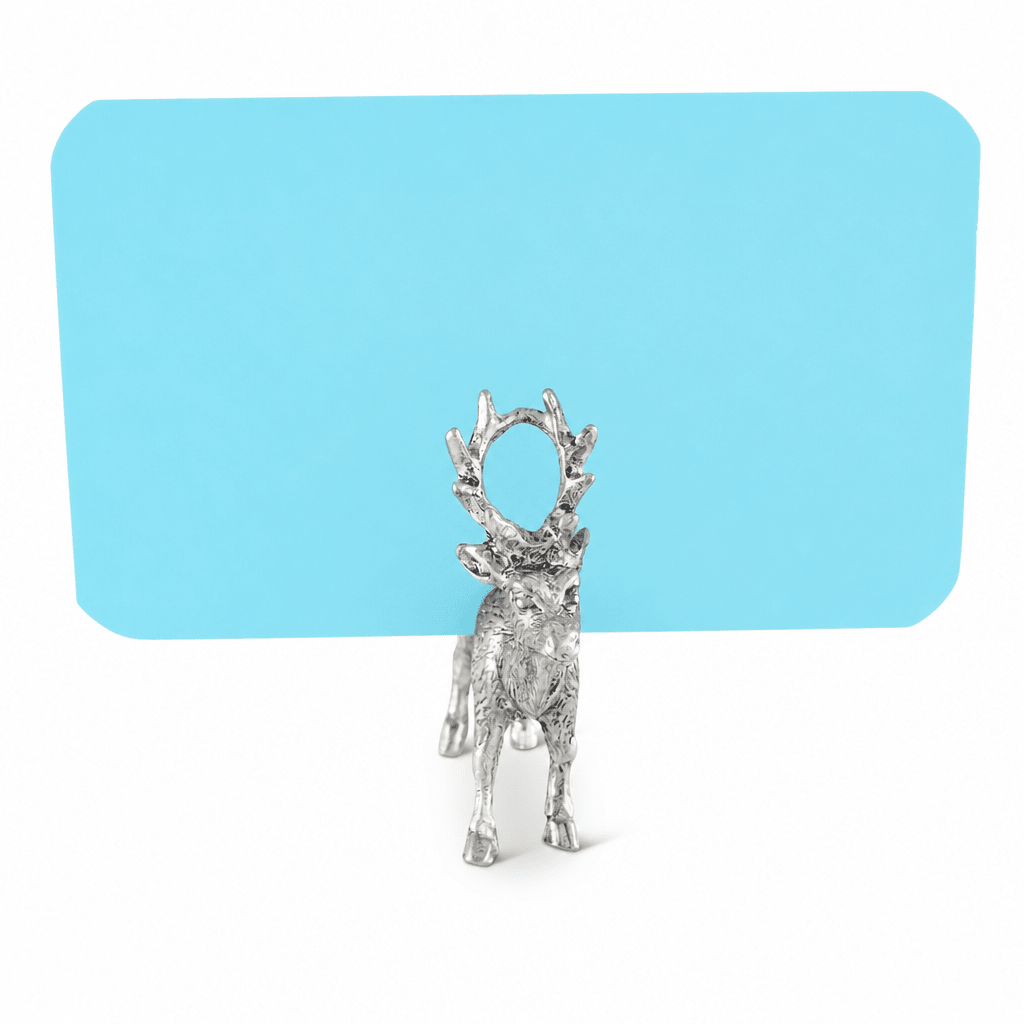 Pewter deer place card holder holding a blank blue card in its antlers on a white background