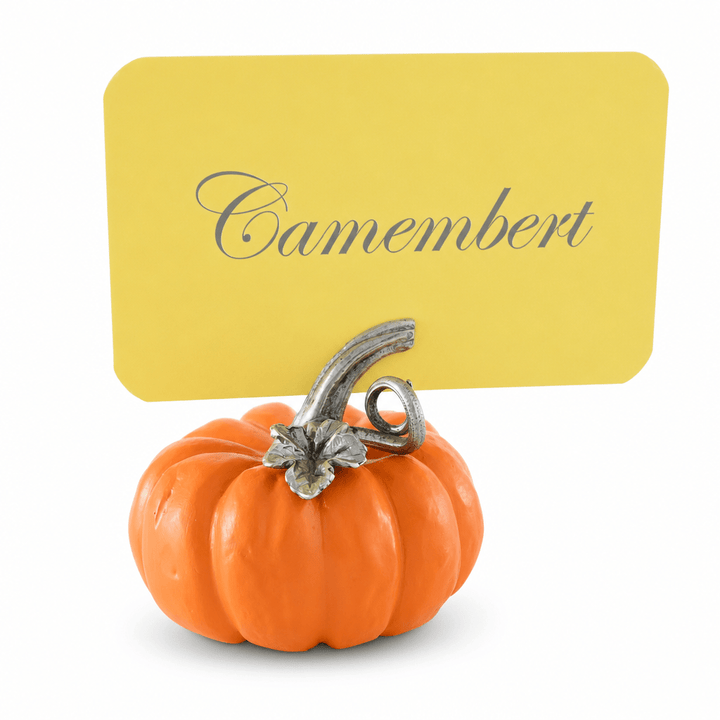 Orange resin pumpkin place card holder with a pewter stem holding a yellow Camembert card