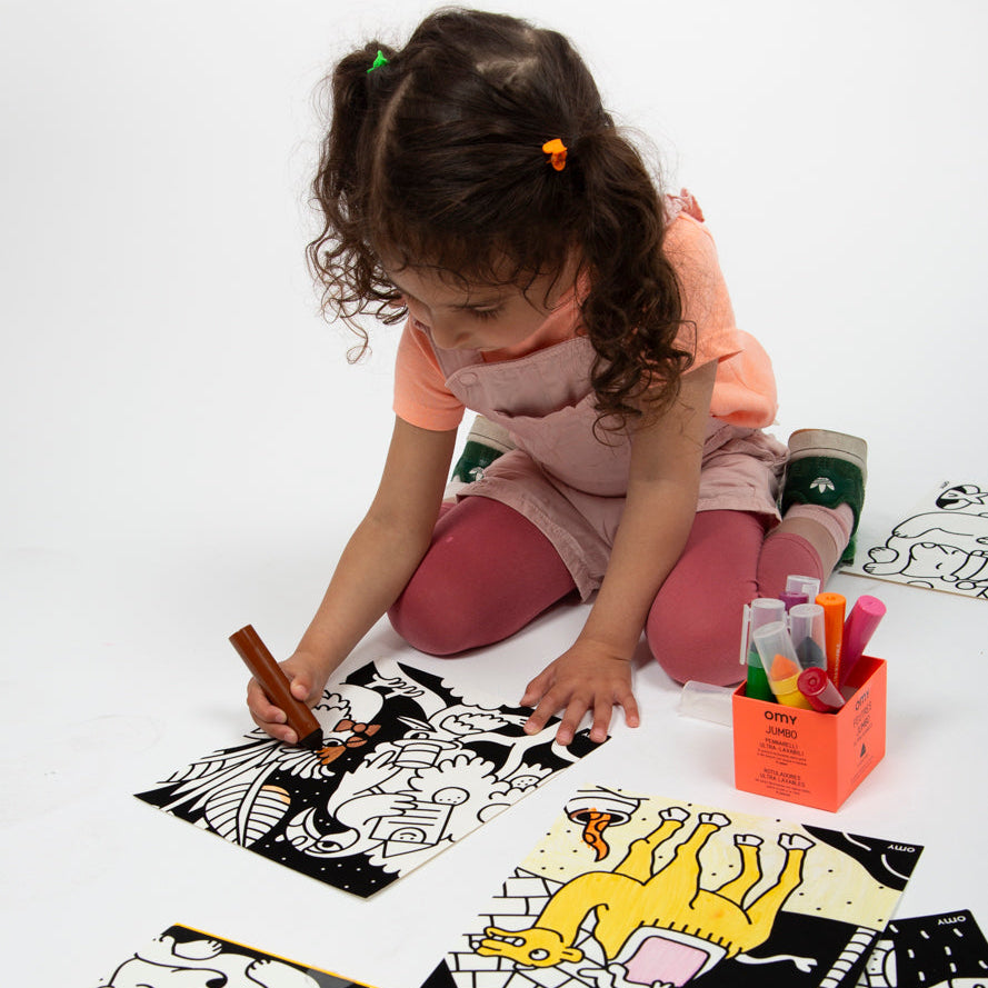 Child coloring the velvet animal panels during playtime