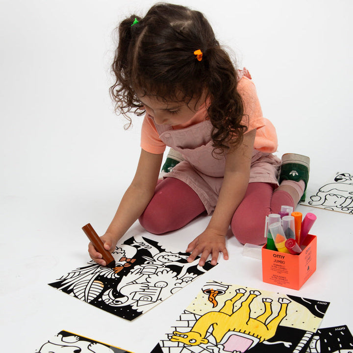 Child coloring the velvet animal panels during playtime