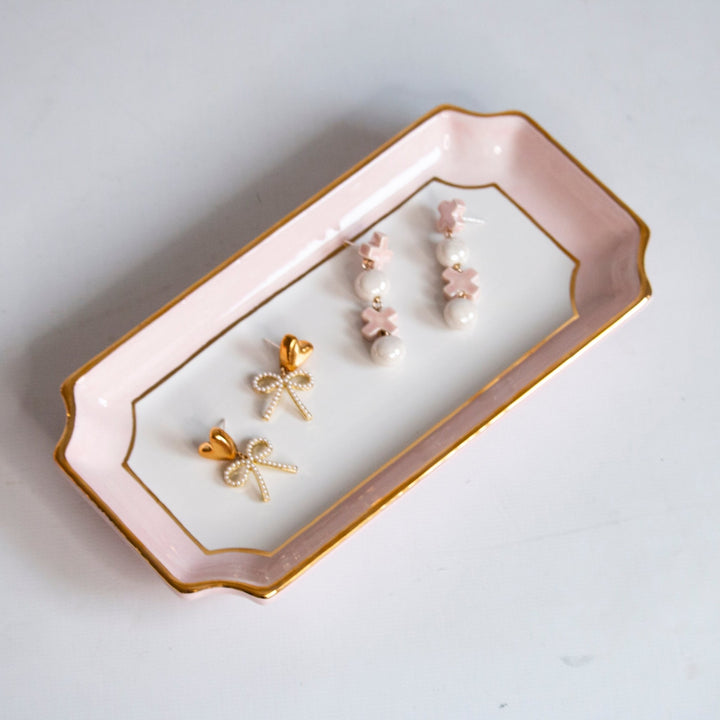 Blush pink petite valet tray with gold trim holding pearl and gold flower earrings for a Valentine's gift