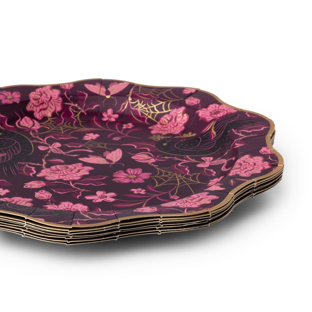 Stack of plum scalloped Halloween dinner plates showing the gold rim and floral spider-web print