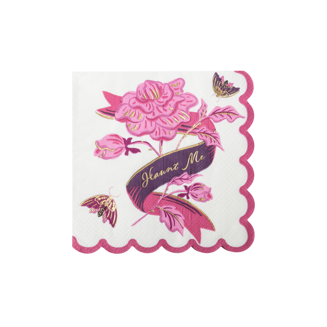 A square white paper napkin with a scalloped pink border, featuring a pink rose, butterflies, and a dark purple ribbon banner with the text 'Haunt Me'.