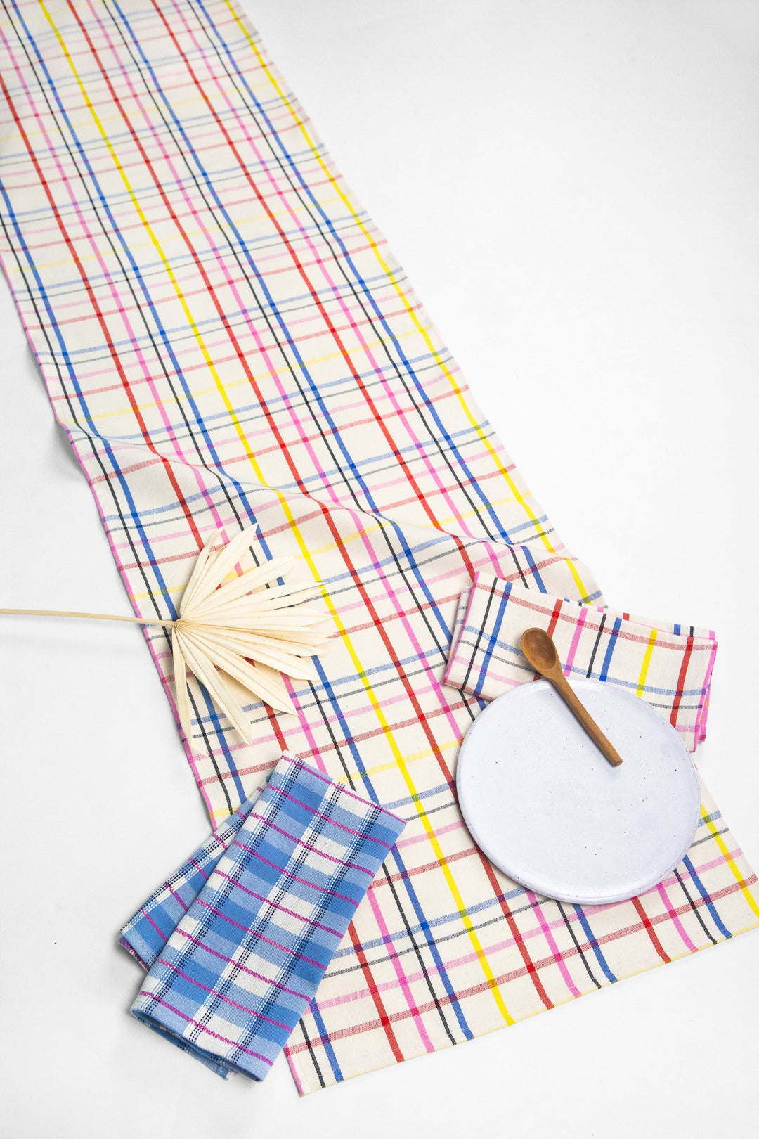 Colorful multicolor plaid table runner styled on a table for a celebration
