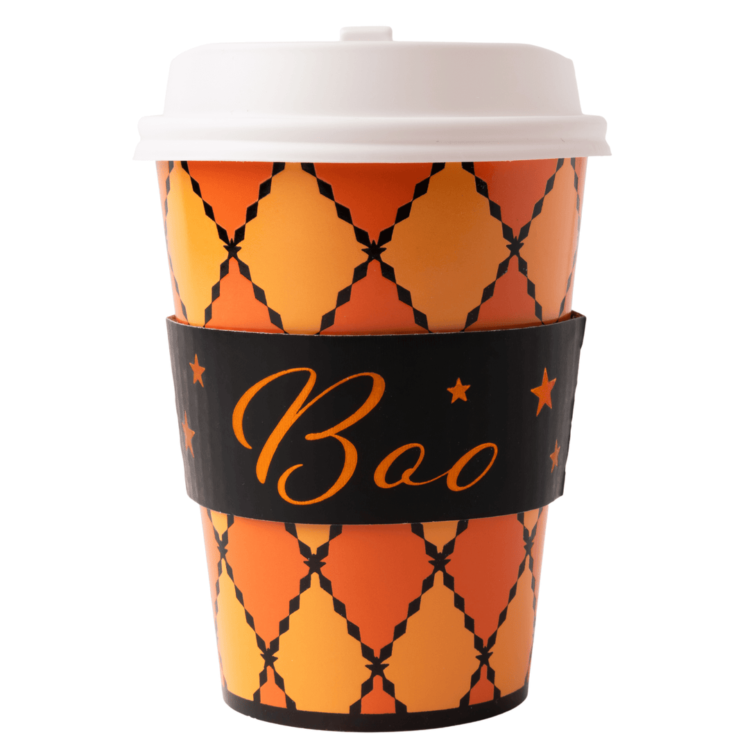 A Halloween-themed paper coffee cup with a white lid, featuring an orange and yellow harlequin pattern with black outlines and a black wrist strap printed with 'Boo' in orange script and stars.