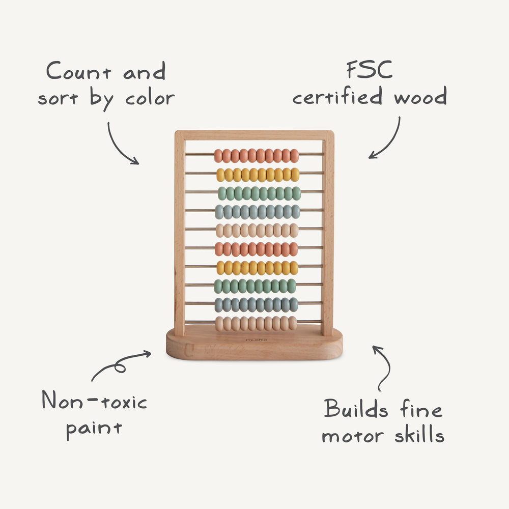 Infographic of the Mushie wooden abacus: FSC-certified wood and non-toxic paint for counting and color sorting