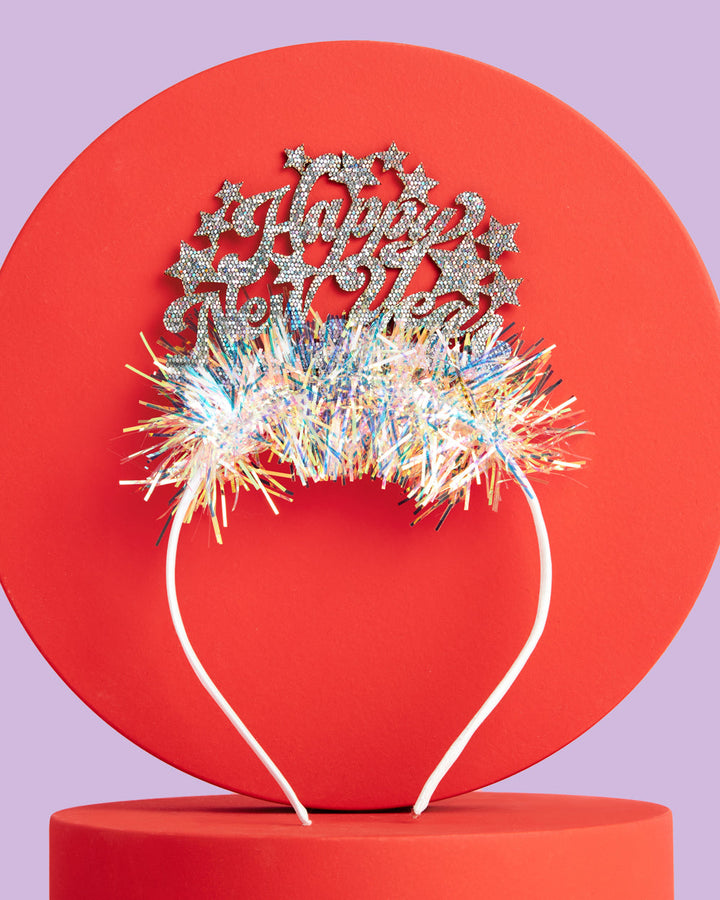 Silver glitter Happy New Year lettering and stars on the fringe headband
