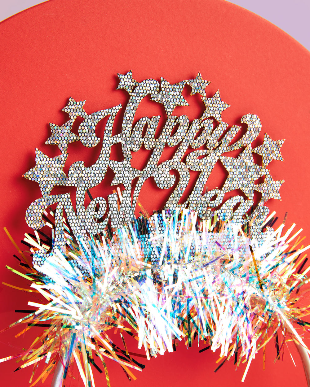 Happy New Year glitter headband with stars against a red background