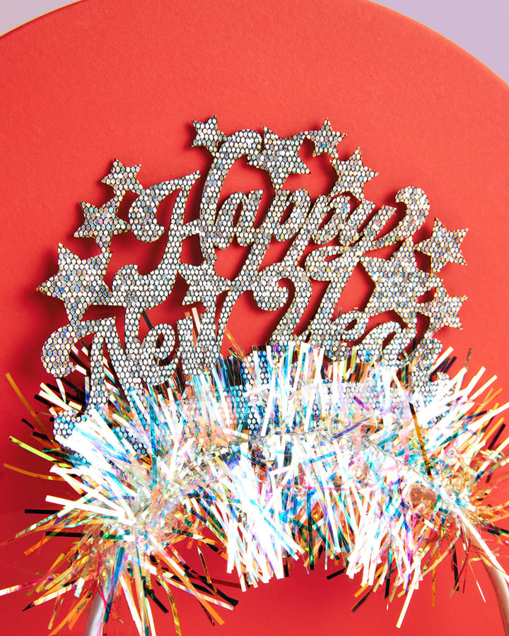 Happy New Year glitter headband with stars against a red background