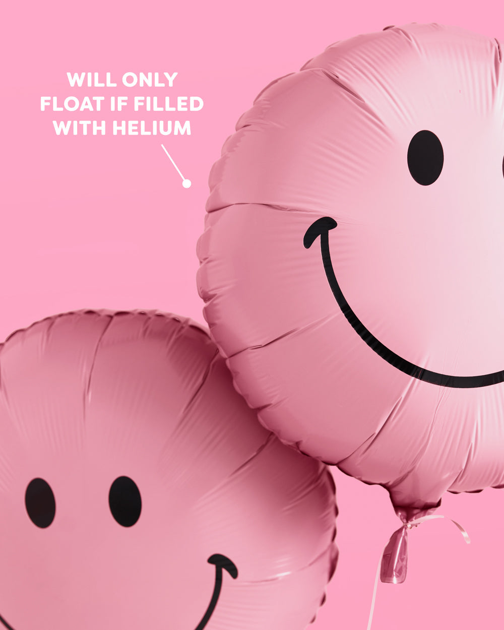 Pink smiley face balloons styled as a backdrop