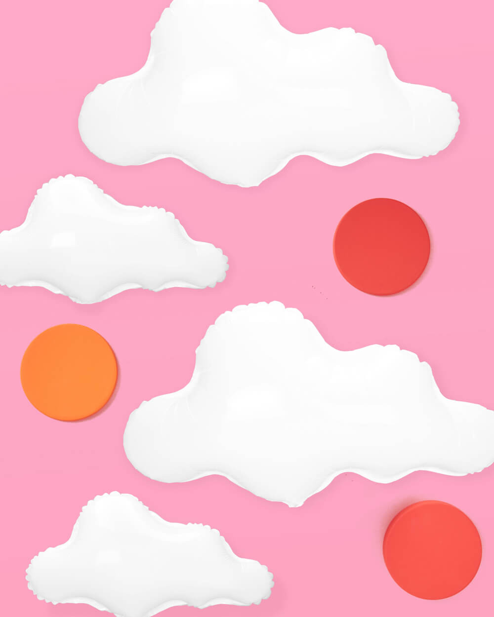 White cloud foil balloons styled as a party backdrop