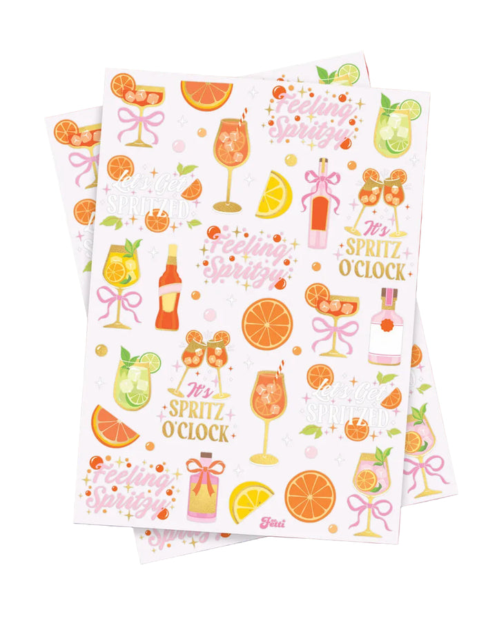Two sheets of spritz temporary tattoos showing citrus and cocktail designs in gold foil