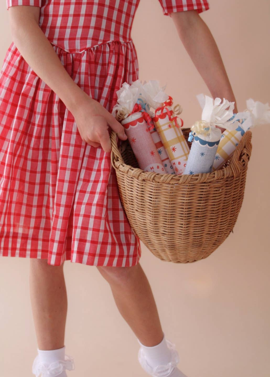 Basket of jumbo surprise bon bons carried by a girl in red gingham, favors for birthdays and picnics