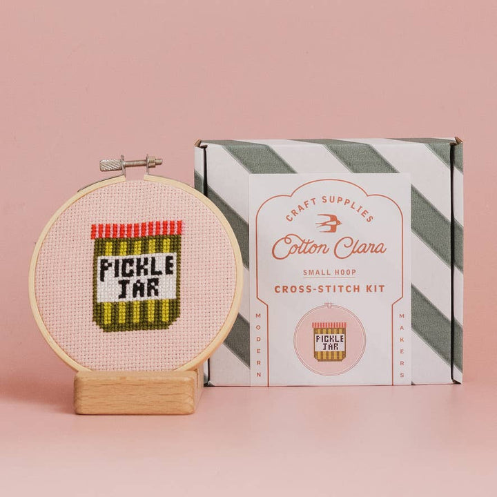 Pickle jar cross stitch hoop beside Cotton Clara small hoop kit box
