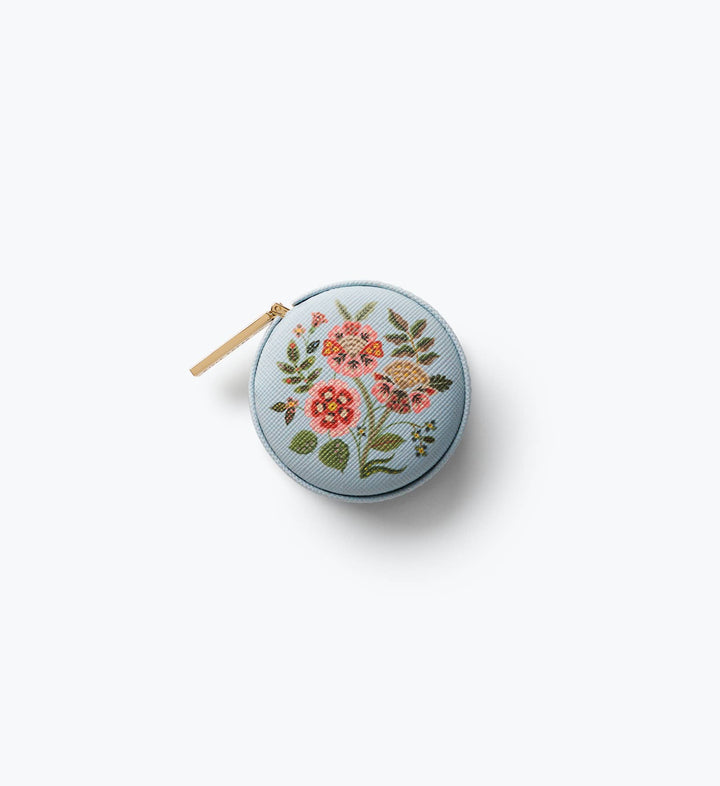 Light blue Gracie measuring tape case with pink block-print florals and gold pull, a giftable sewing kit staple