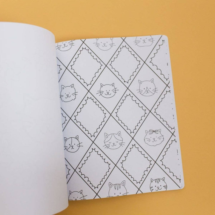 Cat coloring page with cat faces in a scalloped diamond pattern, ready for markers