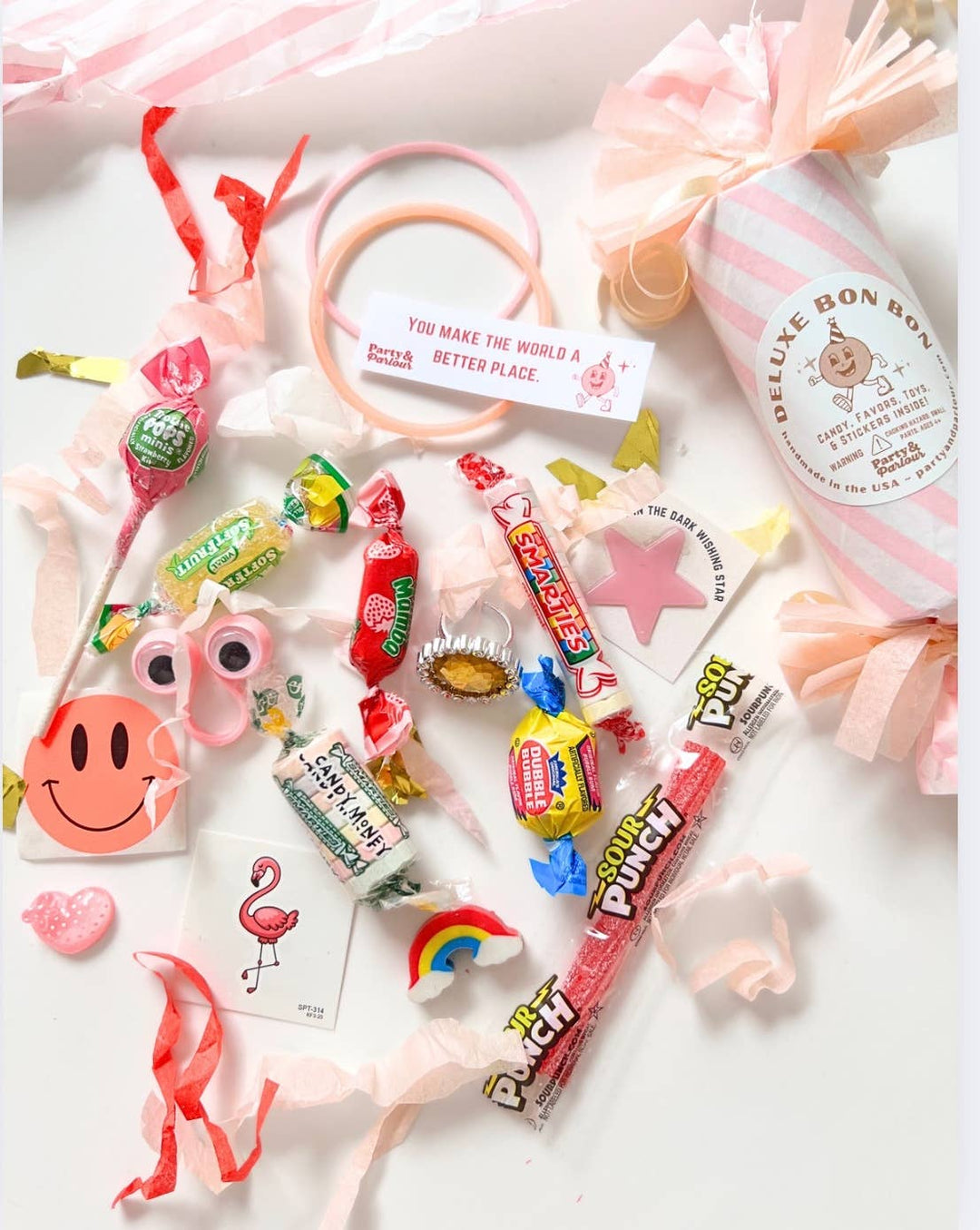 Pink bon bon surprises: flamingo tattoo, friendship bracelets, smiley sticker, and retro candy for sleepover favors