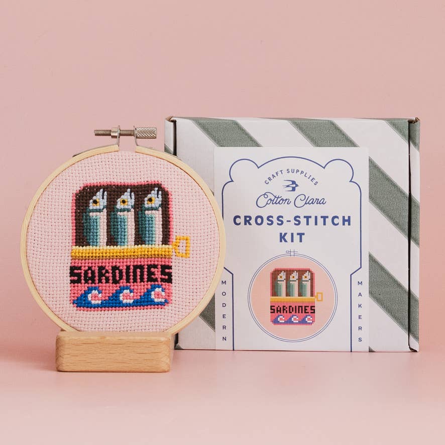 Sardines cross stitch hoop beside Cotton Clara striped kit box for craft night gifting