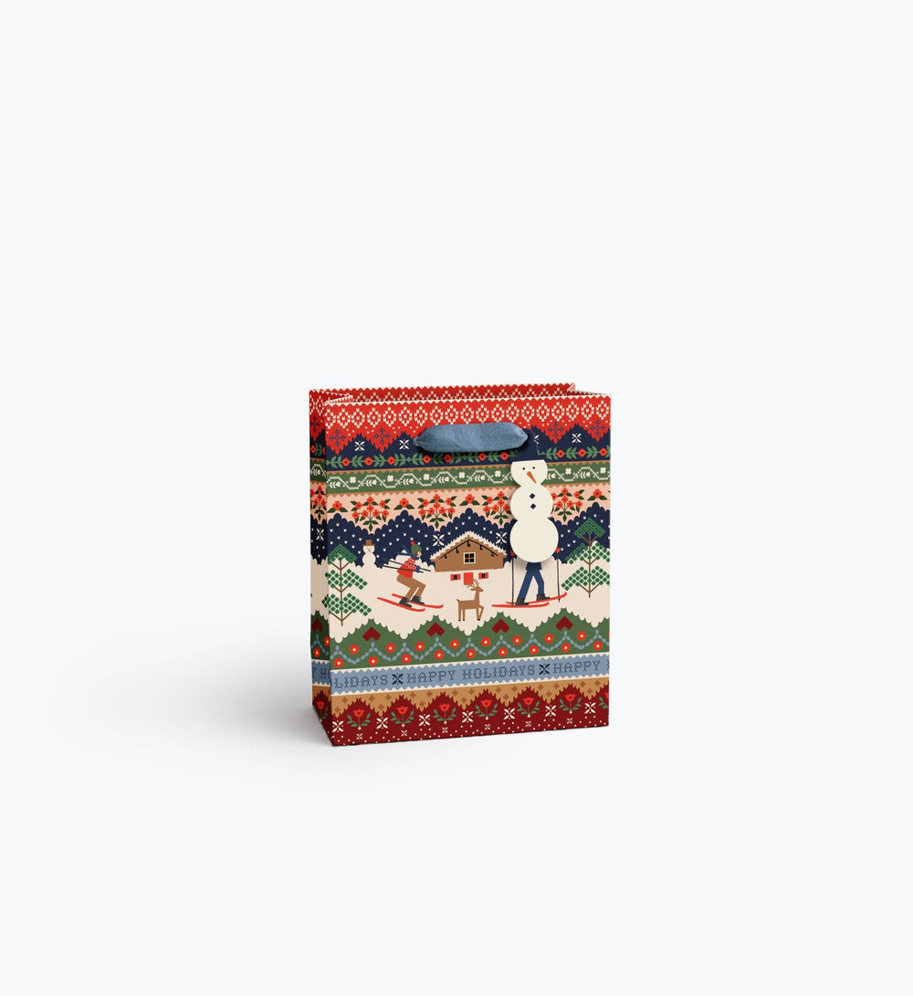 Ski Chalet holiday gift bag with snowman tag and slate blue ribbon handles in fair isle print