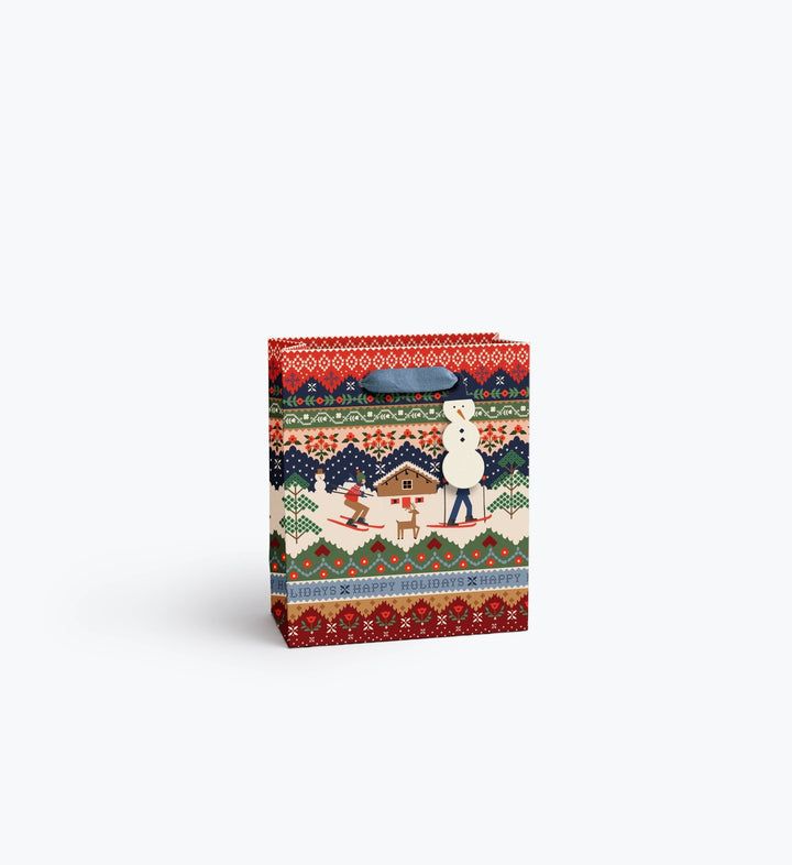 Ski Chalet holiday gift bag with snowman tag and slate blue ribbon handles in fair isle print