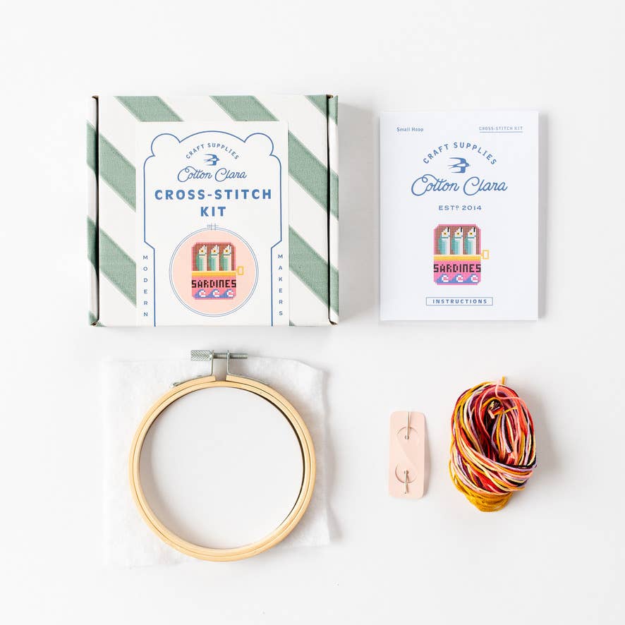 Sardines cross stitch kit contents with hoop, fabric, needle, thread, and instructions