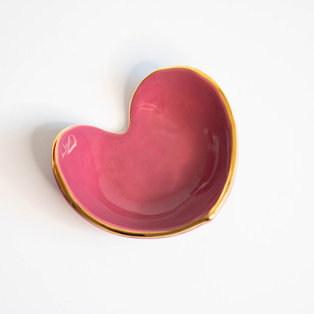 Berry pink heart ring dish with a gold rim, side angle