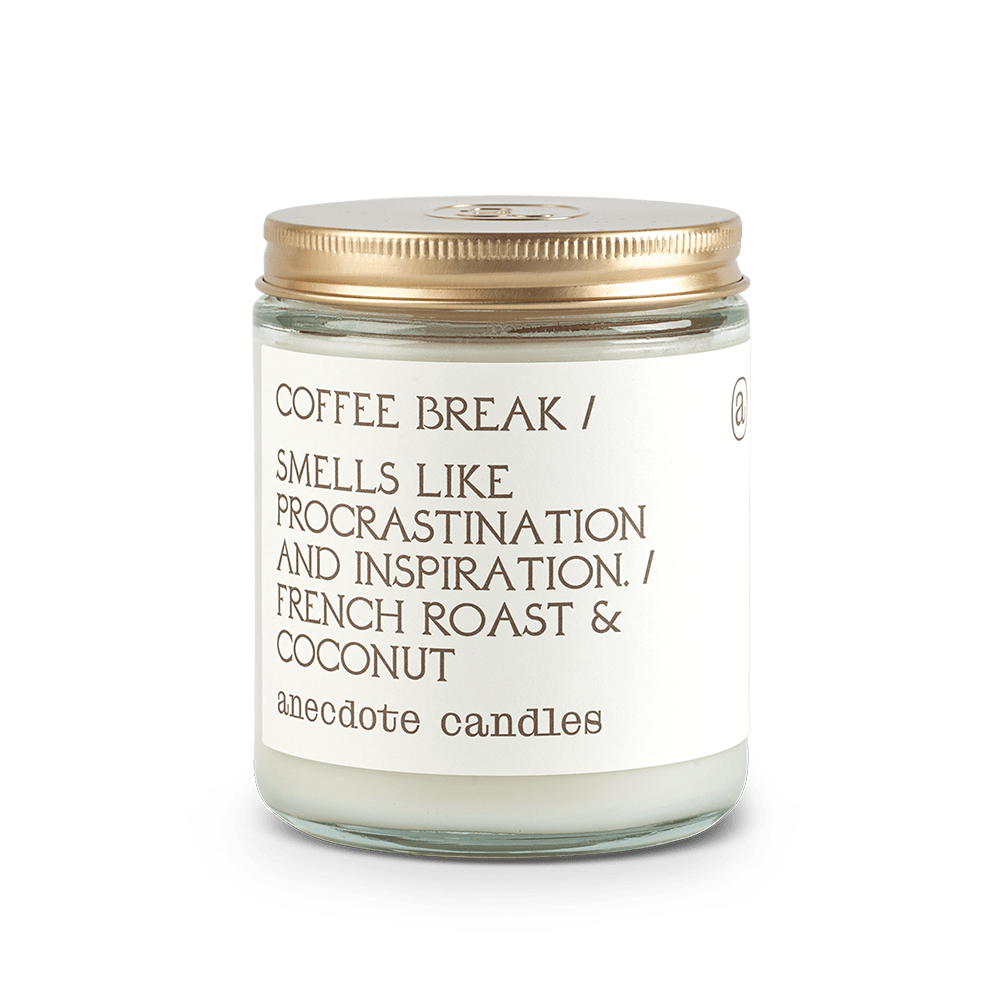 Coffee Break French roast and coconut candle in a clear glass jar with a white label and gold lid