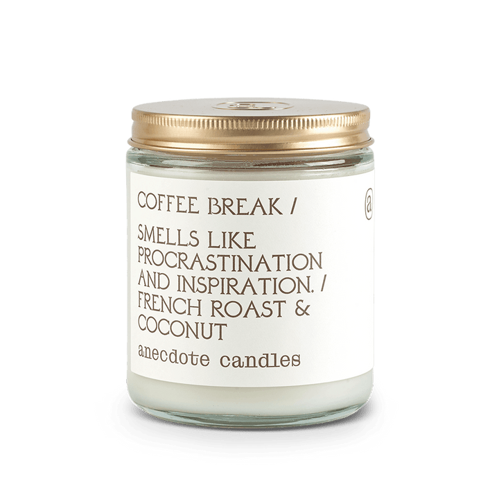 Coffee Break French roast and coconut candle in a clear glass jar with a white label and gold lid