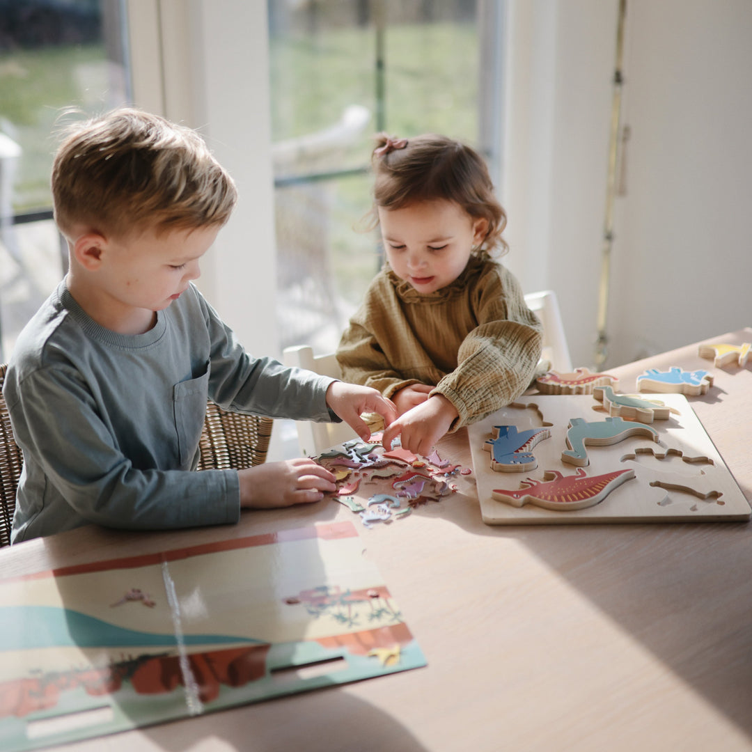 Child using a Mushie reusable sticker book