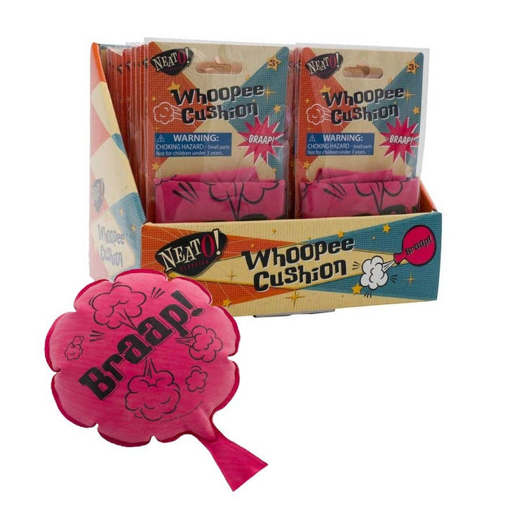 Pink Braap whoopee cushion in front of the Neato display box, a retro gag gift for April Fools pranks
