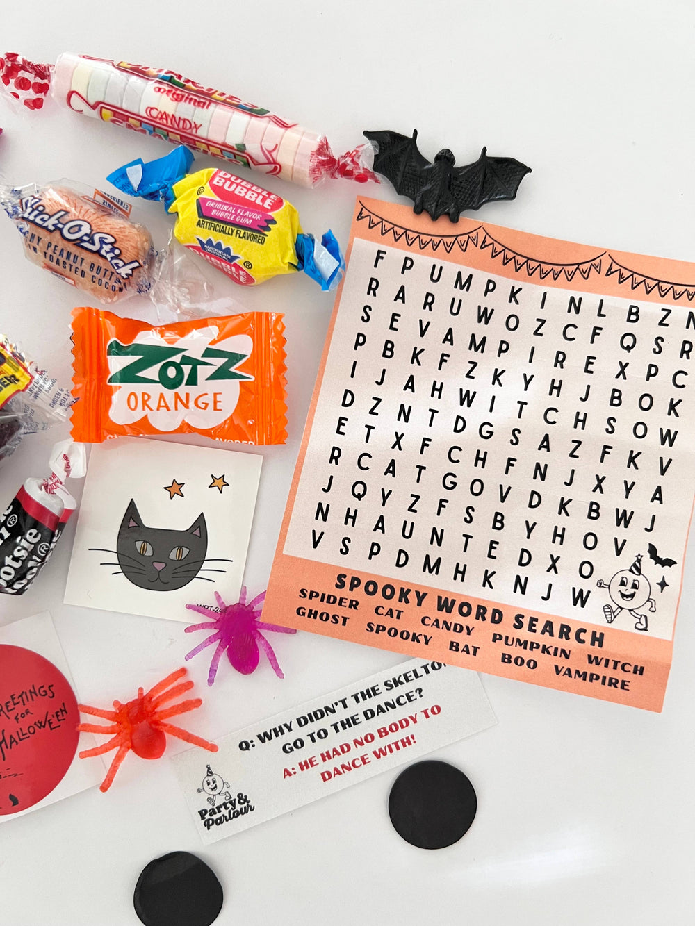 Striped Halloween bon bon goodies: spooky word search, candies, spider rings, and a black cat tattoo for class parties