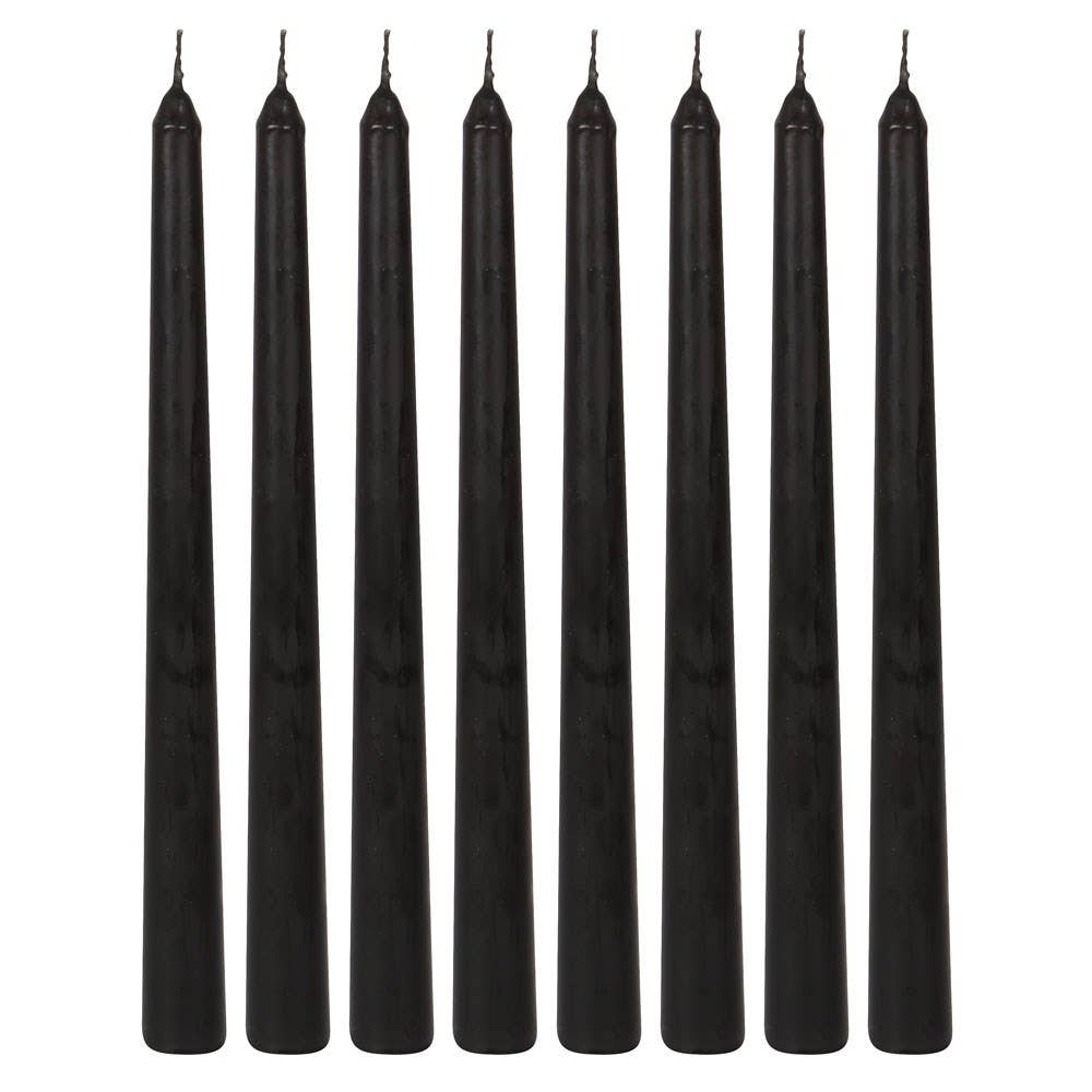 Eight unlit black taper candles lined up in a row, ready to bleed red at a Halloween gathering