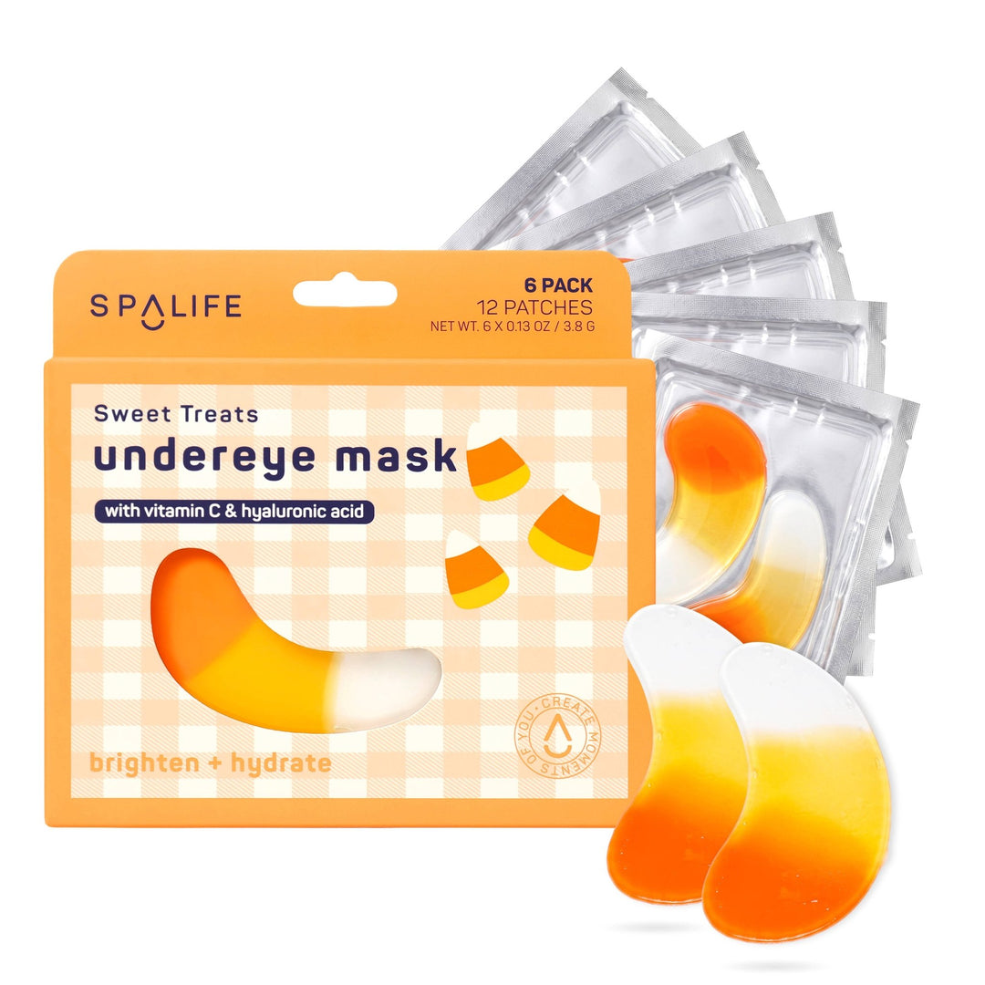 Candy corn under eye patches and foil sachets fanned out behind the orange six pack box for Halloween pampering