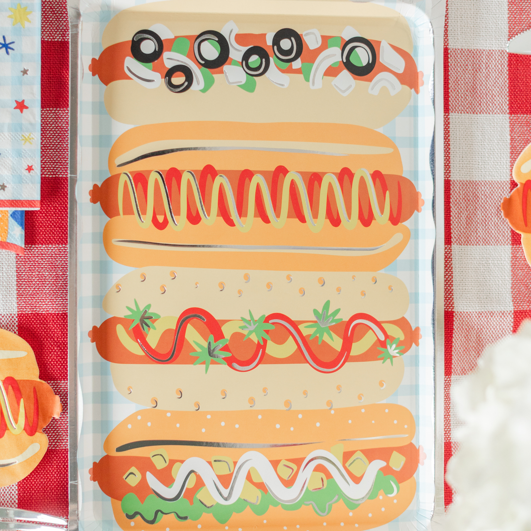 Hot dog platter plate on a red gingham table with coordinating cookout napkins