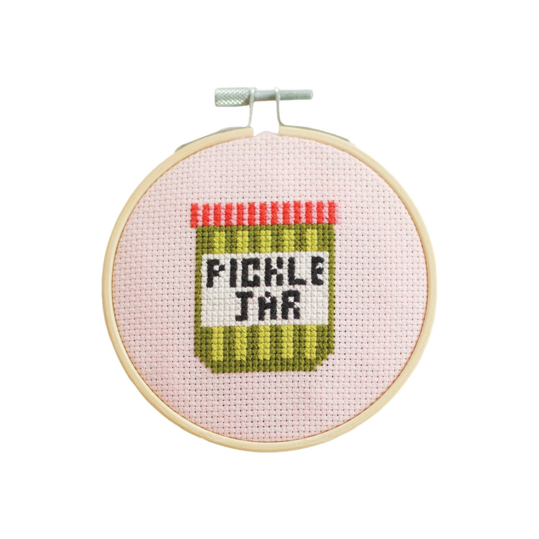 Pickle jar cross stitch hoop with striped jar design on pale pink aida fabric