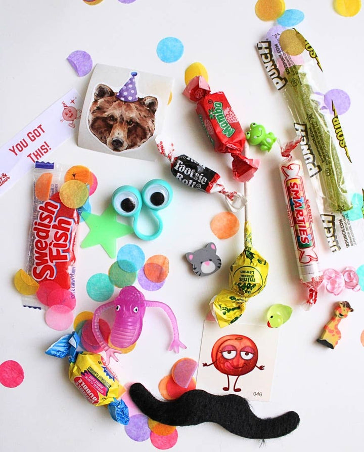 Toys and treats from the blue plaid jumbo bon bon: stickers, tattoos, retro candy, and confetti for celebration favors