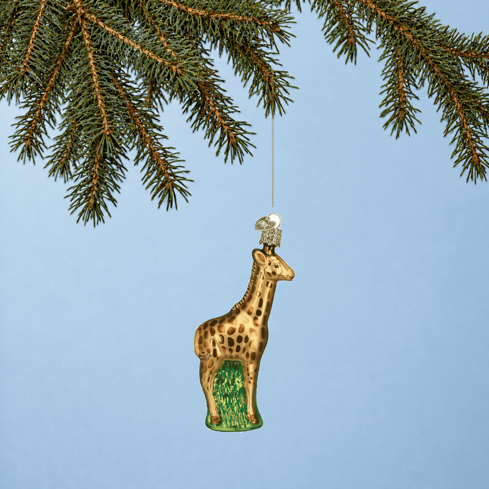 Baby giraffe Christmas tree ornament hanging from a branch 