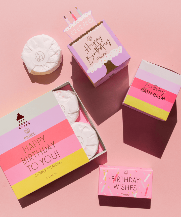 Musee birthday flatlay with bath balm, shower steamers, and Birthday Wishes boxes for a kids birthday party