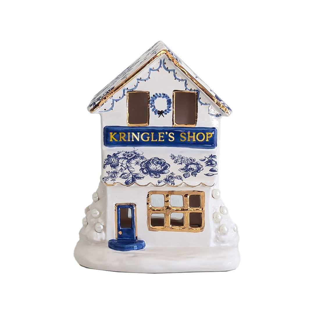 Decorative house-shaped container with 'Kringle's Shop' text on a white background