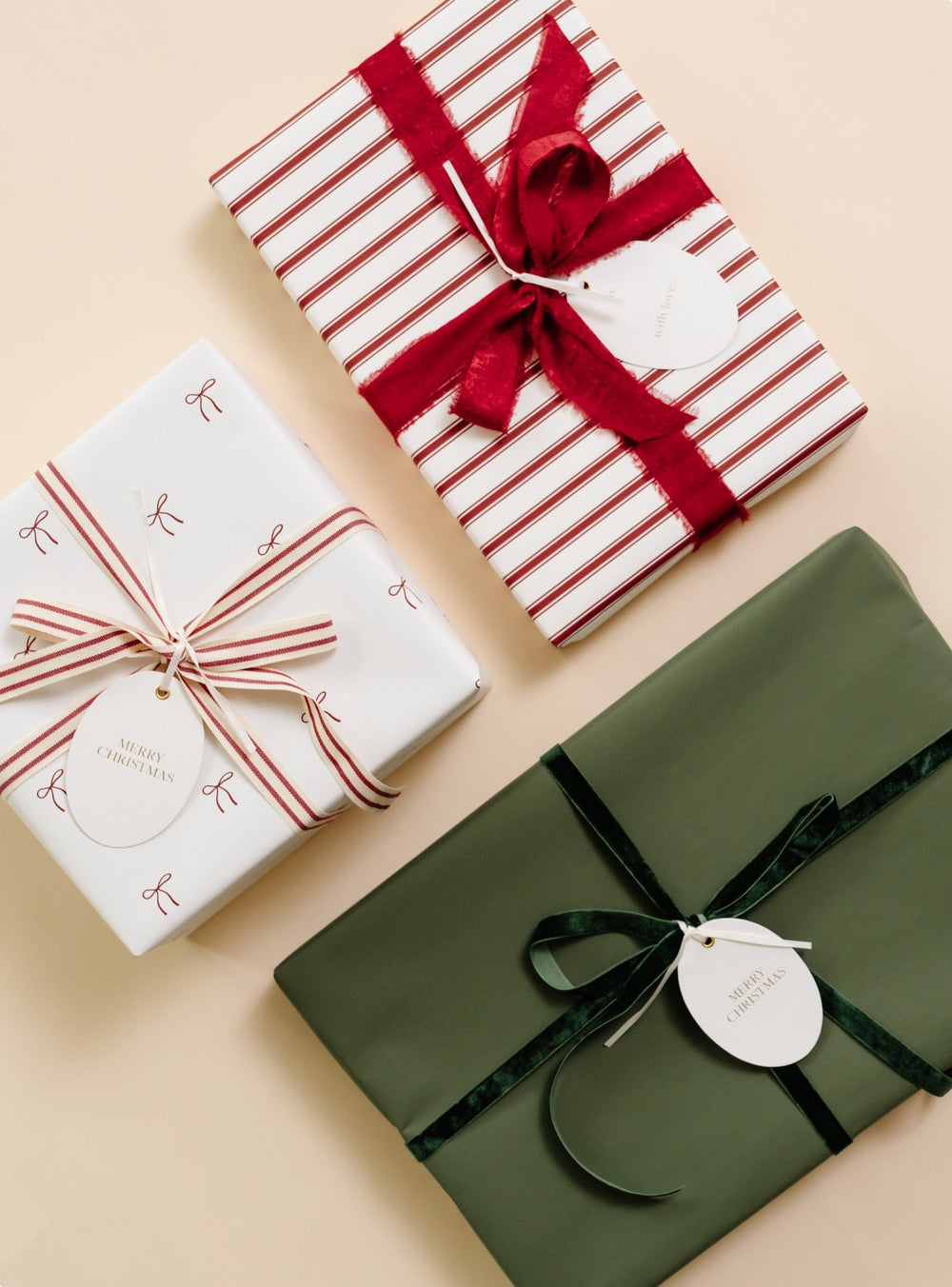 Gifts in tiny red bow print, red candy stripe, and soft green paper with velvet and striped bows