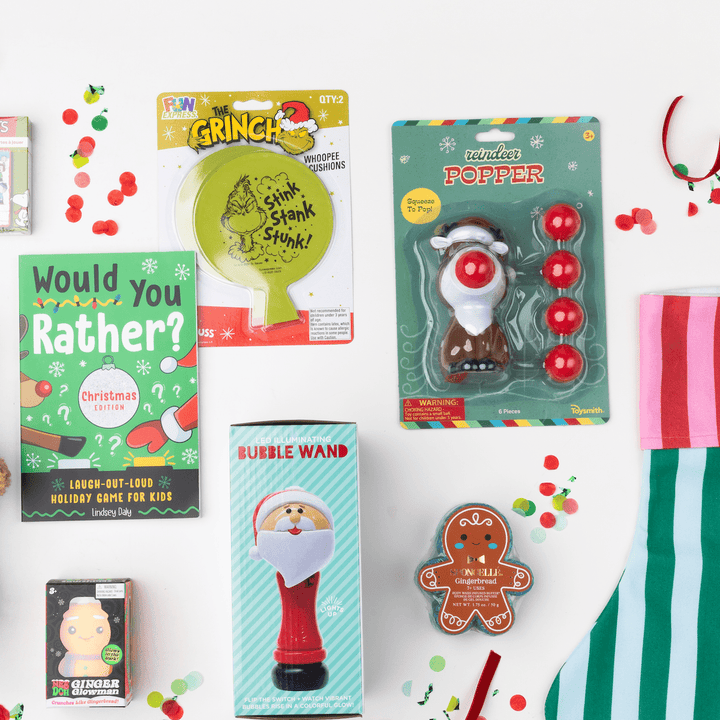 Christmas stocking stuffer flat lay with the reindeer popper, holiday game book, and bubble wand for kids