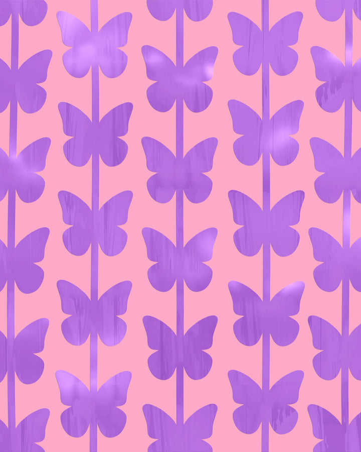 Purple butterfly foil curtain strands hung close together as a butterfly party backdrop