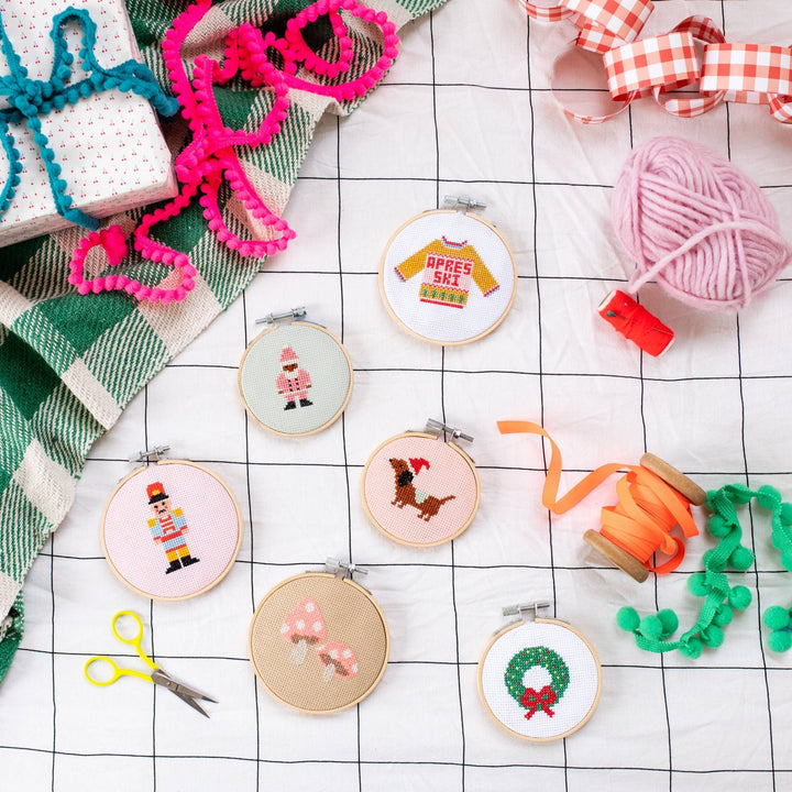 Cotton Clara mini Christmas cross stitch hoops including the apres ski sweater design