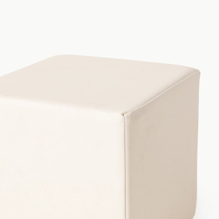 Ivory vegan leather foam play cube, close-up of the soft wipeable surface.