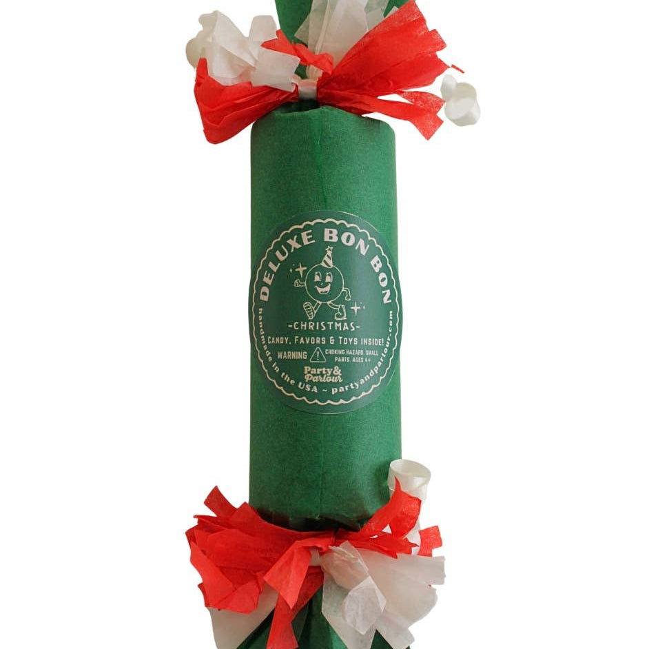 Green Deluxe Bon Bon party favor with a white seal label and red and white fringed paper ends, for a Christmas party