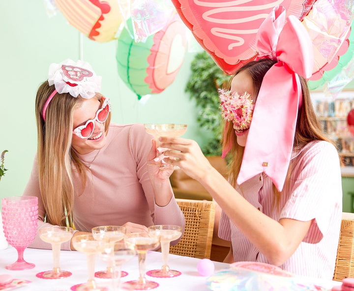 Champagne pong party game set with 12 coupes, 12 coasters, and 2 pink pong balls