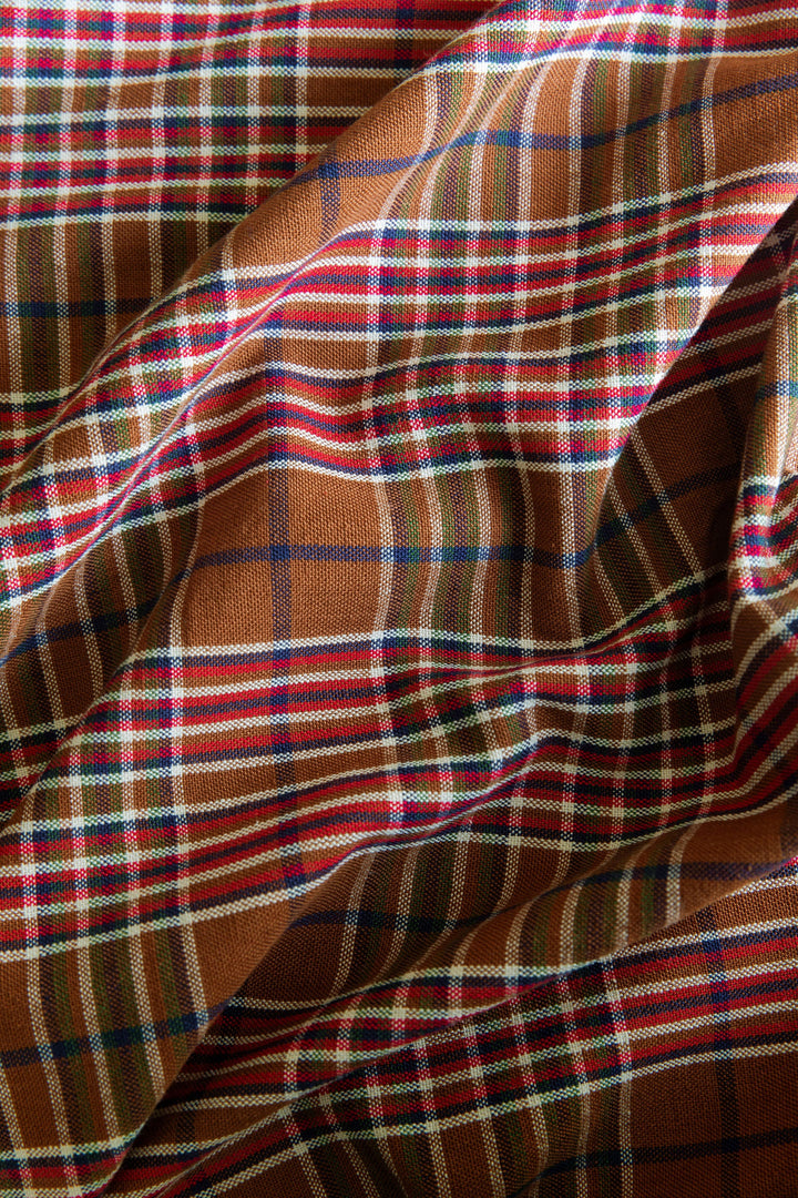 Close-up of the Charlotte plaid weave showing red and indigo lines over a nutmeg ground