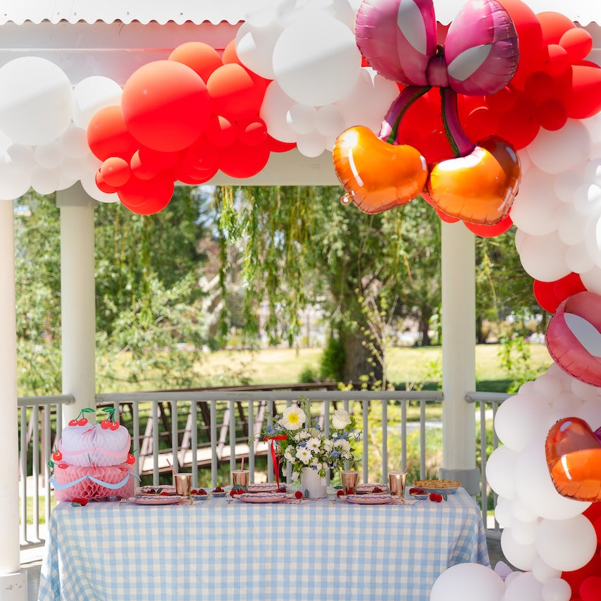 Meri Meri Honeycomb Birthday Cake decoration at a Bonjour Fete cherry pie gingham summer party with balloons